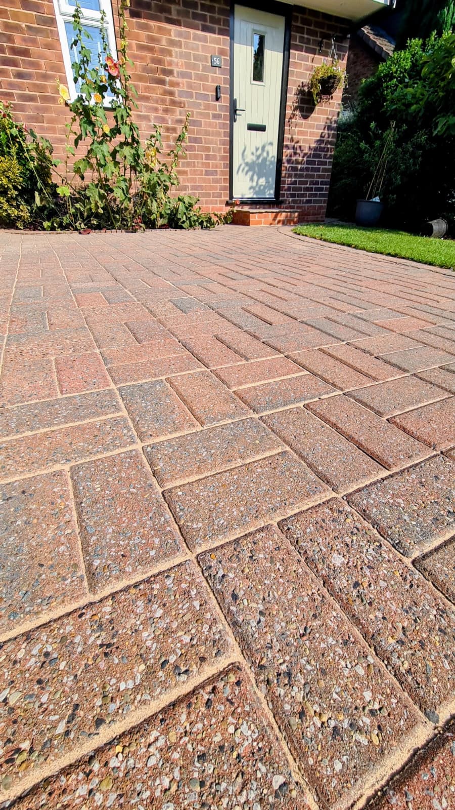 Block paving cleaning Macclesfield — circular patio feature restored removing moss and organic staining