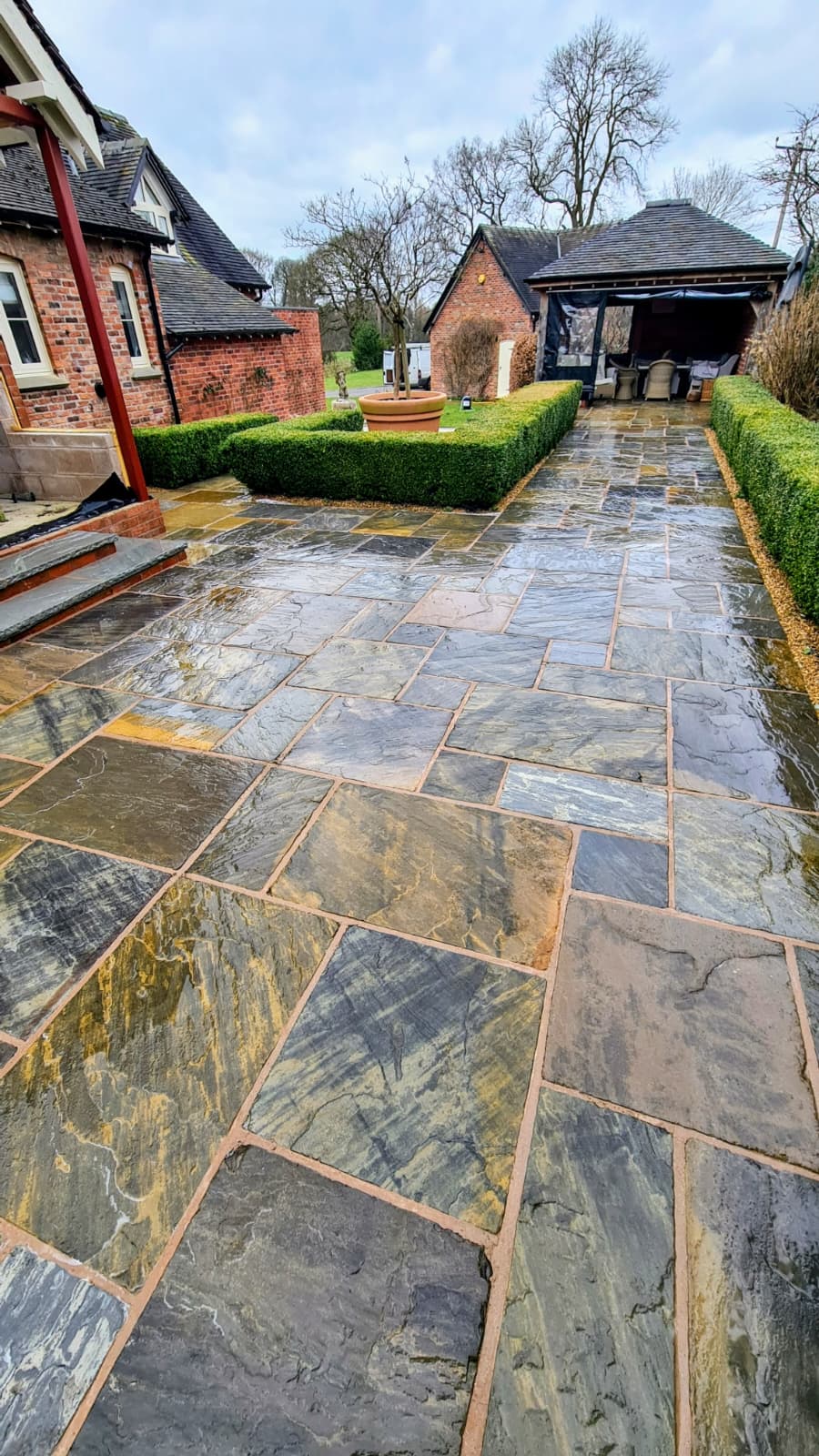 Patio cleaning East Cheshire — sandstone paving restored removing moss algae and years of grime
